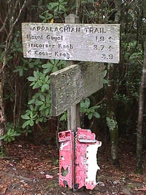 Marker at Lower Cammerer Trail crossing with piece of airplane wreckage at base